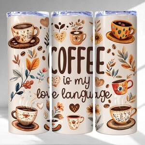 May include: A white tumbler with a brown background and floral designs. The tumbler has the text "COFFEE is my love language" on it. There are multiple images of coffee cups with brown, red, and yellow designs.