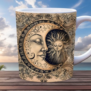 May include: White ceramic mug with a black and white illustration of a crescent moon and sun with a face. The moon and sun are surrounded by a decorative floral design.