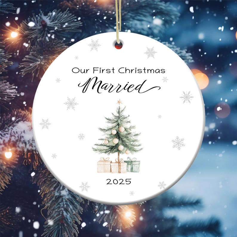 May include: White ceramic Christmas ornament with a green watercolor Christmas tree, presents, and the text "Our First Christmas Married 2025".