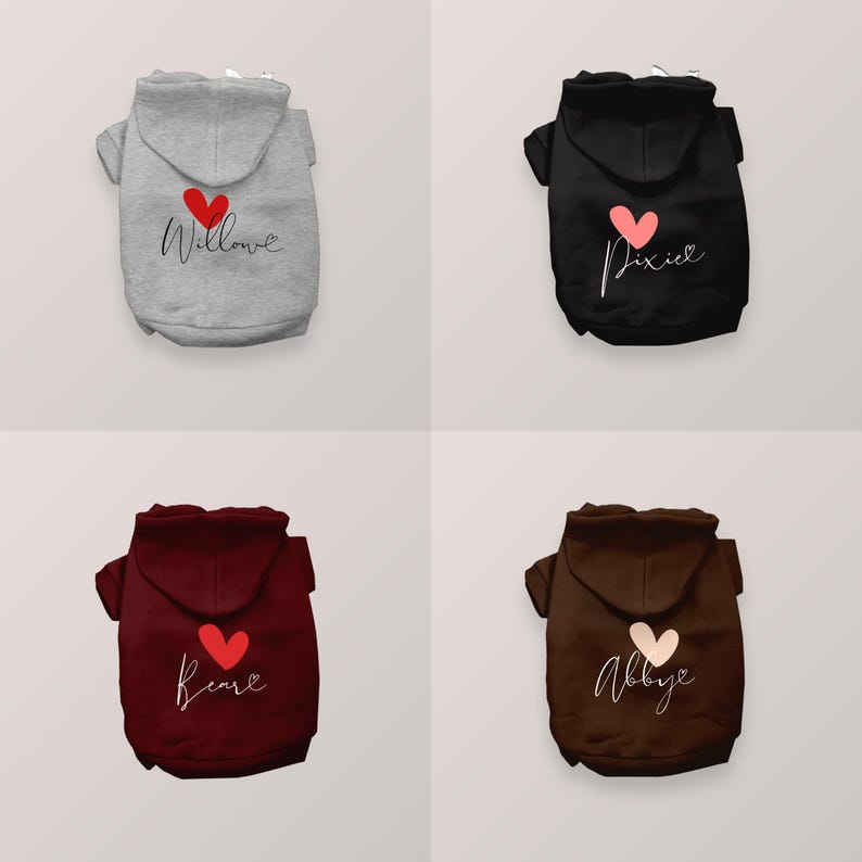 May include: Four pet hoodies in gray, black, maroon, and brown, each featuring a hood and a heart graphic above a name written in cursive script. The names printed on the hoodies are Willow, Pixie, Bear, and Abby, with heart colors matching the text.