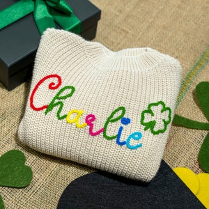 a knitted pillow with a name on it
