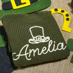 a green knitted hat with a name on it