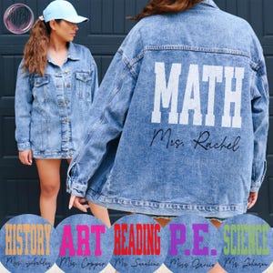 May include: Light blue denim jacket with the word "MATH" printed on the back in white block letters, with "Mrs. Rachel" underneath. The jacket has a button-up front and pockets. Additional jackets with "HISTORY", "ART", "READING", "P.E.", and "SCIENCE" are also shown.