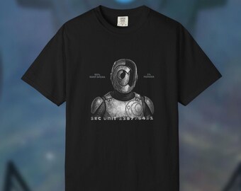 May include: Black t-shirt featuring a futuristic robot design with the text "99% Soap Opera, 1% Murder" and "SEC UNIT 238776431". The robot has a circular eye and armor-like details. The shirt is a crew neck.