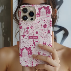 May include: A white iPhone case with a pink and white design. The design features a variety of illustrations including hearts, a skull, a skeleton, a dice, a bear, a gate, a street sign that reads '16th Avenue', and the word 'LOVE'.