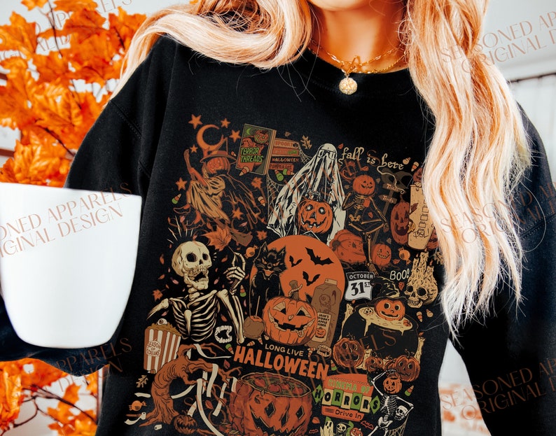 May include: Black sweatshirt with a vintage Halloween design featuring a skeleton, pumpkins, bats, ghosts, and the text "Long Live Halloween" and "Fall is Here".