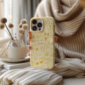 May include: A white iPhone case with a yellow design featuring beach-themed illustrations and the text "Meet me at the Beach".