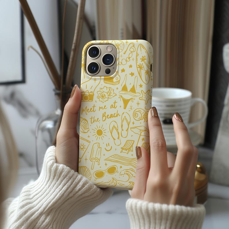 May include: A white iPhone case with a yellow design featuring beach-themed illustrations, including flip flops, sunglasses, ice cream, and the text "Meet me at the Beach".