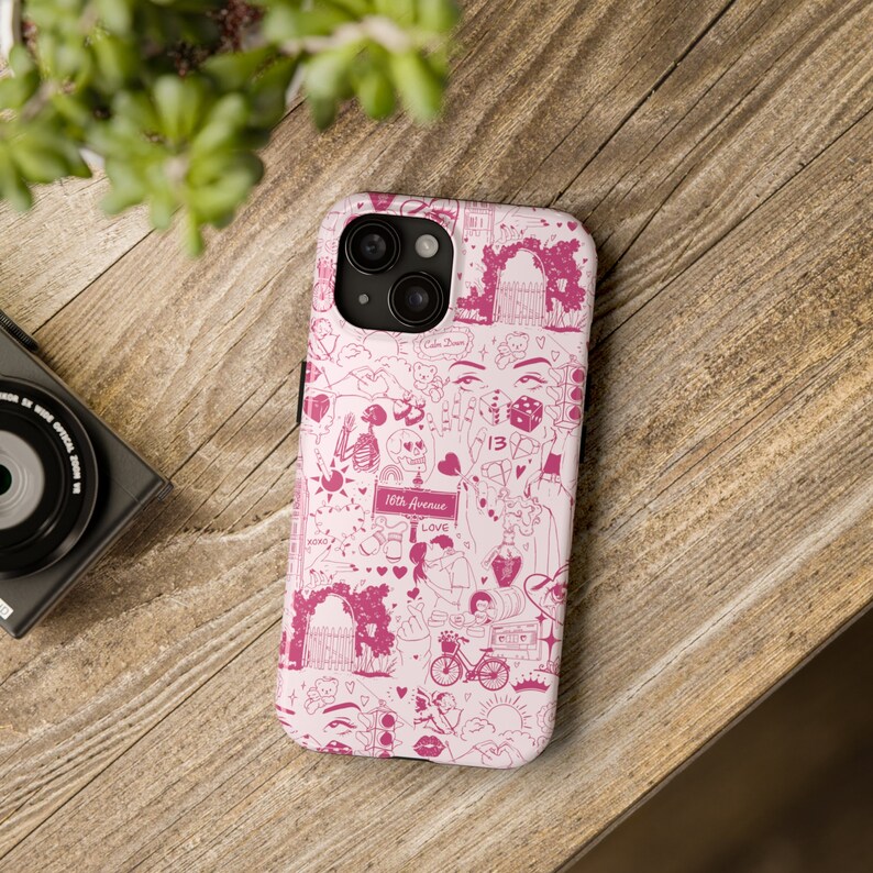 May include: A pink phone case with a white background and a pink and white design. The design features hearts, stars, and other symbols. The text "16th Avenue" and "Love" are also included in the design.