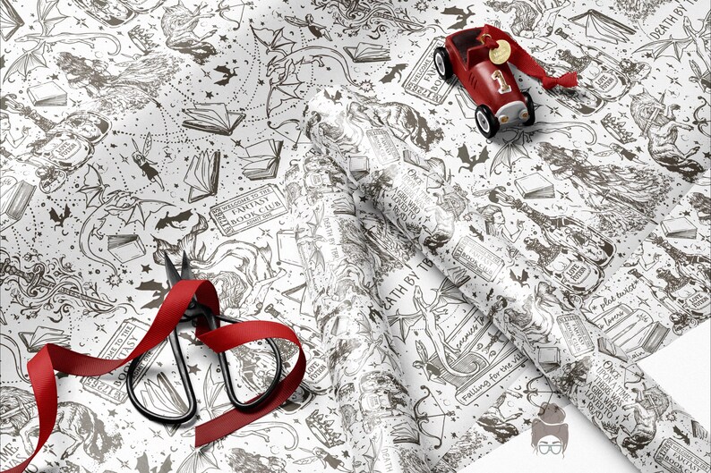 May include: White wrapping paper with a black fantasy illustration, featuring dragons, books, and stars. A red toy car and scissors with a red ribbon are on the paper. The text "DEATH BY TB" is visible on the paper.