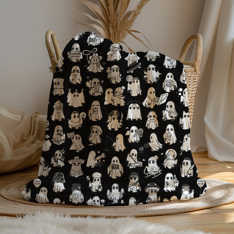 May include: Black and white throw blanket with a repeating pattern of ghosts in various poses and activities. The ghosts are wearing hats, holding books, playing instruments, and more. The text "Dead Inside" and "Boo" are visible on the blanket.