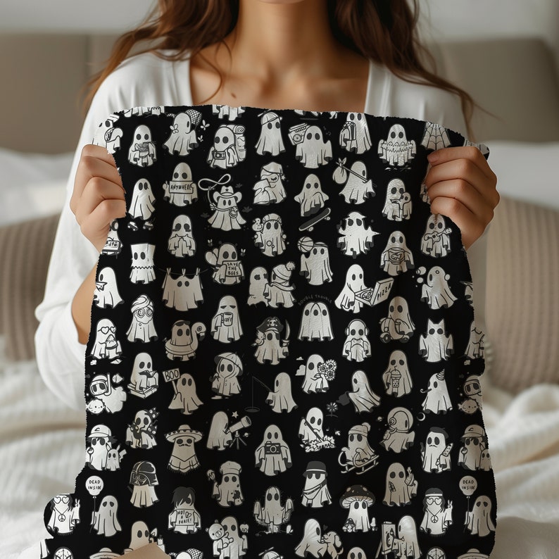 May include: A black and white throw blanket with a repeating pattern of ghosts. Each ghost has a different expression and is holding a different object, such as a book, a cup of coffee, a telescope, a skateboard, a boombox, a camera, a paintbrush, a flower, a balloon, a peace sign, a mushroom, and a music note. The ghosts are all outlined in black and have a white fill. The background is black.