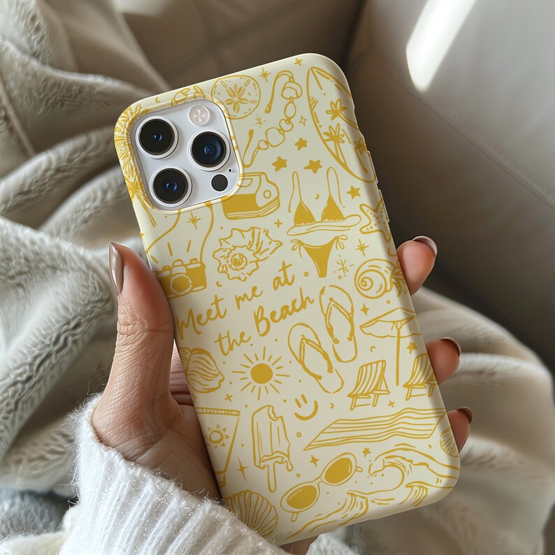 May include: A yellow and white phone case with a beach-themed design. The case features illustrations of sunglasses, flip flops, a surfboard, a seashell, and the text "Meet me at the beach".