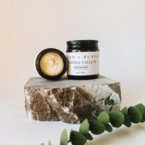 May include: A glass jar of unscented whipped tallow with a black lid. The jar is labeled "Foster + Blake Whipped Tallow Unscented 4oz / 120ml".