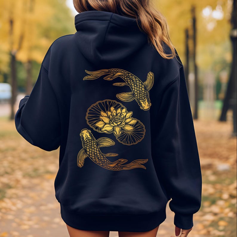 May include: A navy blue hoodie with a gold graphic of two koi fish swimming around a lotus flower.
