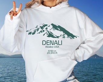 May include: White hoodie with a green mountain graphic and the text "DENALI Alaska-USA 6190 m 20,310 ft"