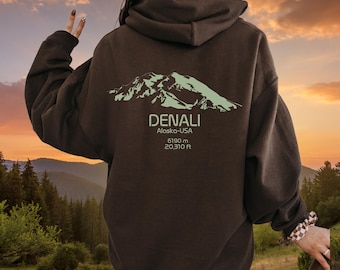 May include: A brown hoodie with a green mountain graphic and the text "DENALI Alaska-USA 6190 m 20,310 ft" on the back.