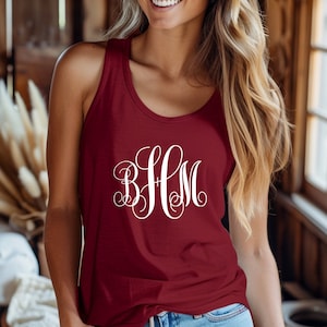 May include: A maroon tank top with a white monogram that reads "BFM".