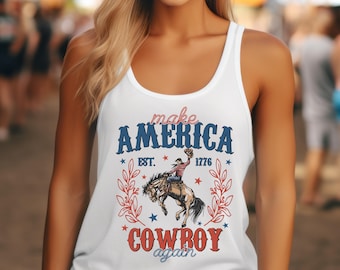 May include: White tank top with a graphic design featuring a cowboy riding a bucking horse. The design includes the text "make america cowboy again" with stars and the text "est. 1776".