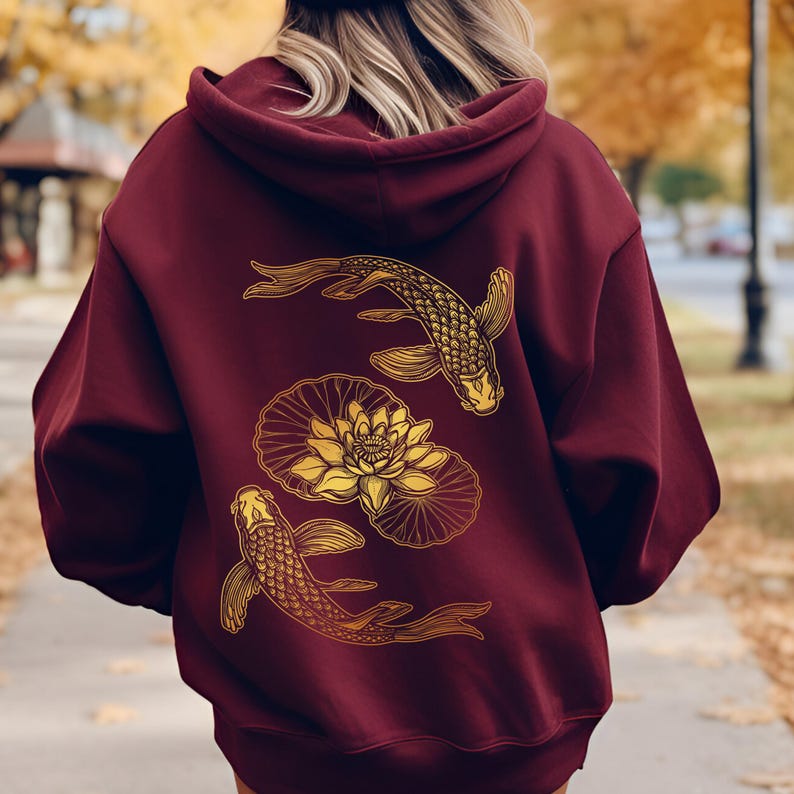 May include: Burgundy hoodie with a gold graphic of two koi fish swimming around a lotus flower.