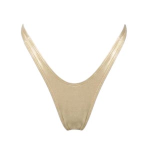 May include: A gold-colored thong swimsuit bottom with a V-shaped front and thin straps. The fabric has a slight sheen, and the edges are neatly stitched. The design is simple and minimalist.