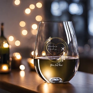 May include: A stemless wine glass with a gold heart design and the text "Wherever you go, I'll be with you". The heart has a small airplane inside and a dotted line extending from the heart. The text "your text here" is below the heart.