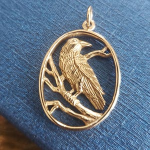 bronze raven pendant in oval frame, talisman charm,