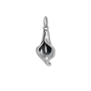 May include: A silver-toned metal pendant shaped like a calla lily flower. The pendant features a smooth, curved petal structure that forms a funnel shape, with a central stamen visible inside and a small circular jump ring attached at the top.