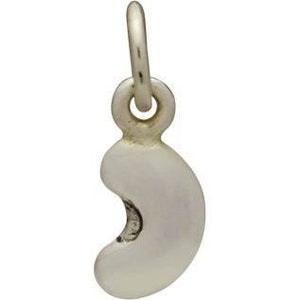 May include: A silver charm in the shape of a crescent moon. The charm has a smooth, rounded surface and a small loop at the top for attaching to a bracelet or necklace.