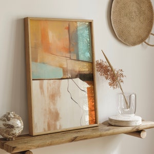 May include: Abstract art print in a wooden frame with muted orange, brown, and blue colors. The print is hanging on a shelf with a vase of dried flowers and a woven basket.