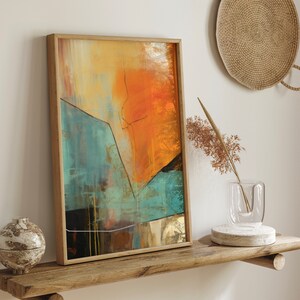 May include: Abstract painting with a wooden frame. The painting features a mix of orange, yellow, blue, and green colors. The painting is on a wooden shelf with a vase and a small decorative object.
