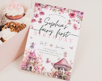 May include: A pink and white fairy-themed birthday invitation with a watercolor illustration of a fairy house, mushrooms, and flowers. The text reads "Join us to celebrate Sophia's fairy first birthday, Feb 25, 2pm-4pm, The Fairy House, 123 Anywhere Street, Any City, RSVP to Mom 123-456-7890".