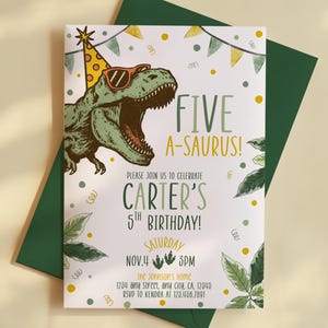May include: A birthday invitation with a green dinosaur wearing sunglasses and a party hat. The invitation reads "FIVE A-SAURUS!" and includes details for Carter's 5th birthday, including the date, time, and location. The invitation is on a white background with green accents.