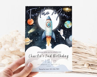 May include: A blue and white rocket ship flies through space with a starry background. The text "Two the Moon" is at the top of the invitation. The text "Charlie's 2nd Birthday" is at the bottom of the invitation.