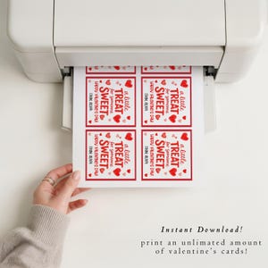 May include: A printer is shown printing Valentine's Day cards. Each card has a red border and features the text "a little TREAT for someone SWEET Happy Valentine's Day! FROM OLIVA" with heart illustrations. The image also includes the text "Instant Download! print an unlimited amount of valentine's cards!"