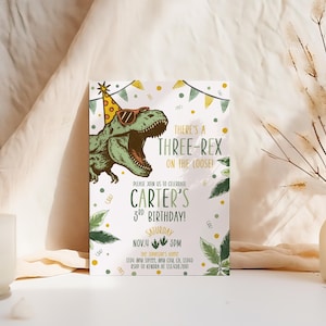 May include: A birthday invitation featuring a green dinosaur wearing sunglasses and a party hat. The text reads "There's a Three-Rex on the Loose!" and announces Carter's 3rd birthday on November 4th at 5 PM. Decorative elements include leaves and confetti.