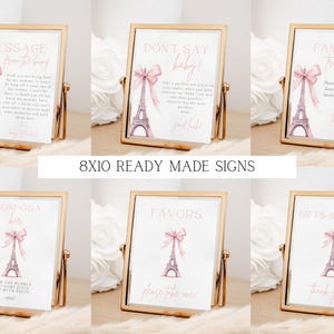 May include: Eight 8x10 inch printable signs with a Parisian theme. The signs feature a pink bow, Eiffel Tower, and text. The signs include: Message from the Bride, Don't Say Baby, Family Traditions, Mom-osa Bar, Favors, and Gifts & Books.