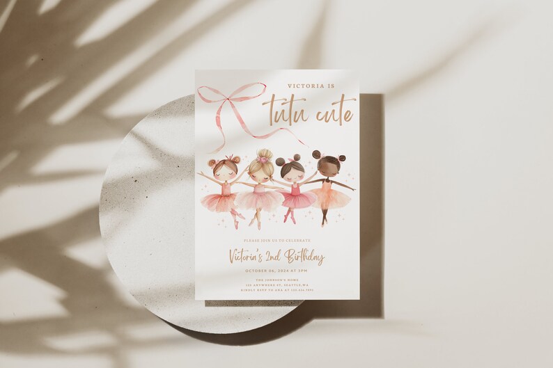 May include: A pink and white invitation card with a pink ribbon bow and four ballerina girls in pink tutus. The text on the card reads "Victoria is tutu cute" and "Victoria's 2nd Birthday".