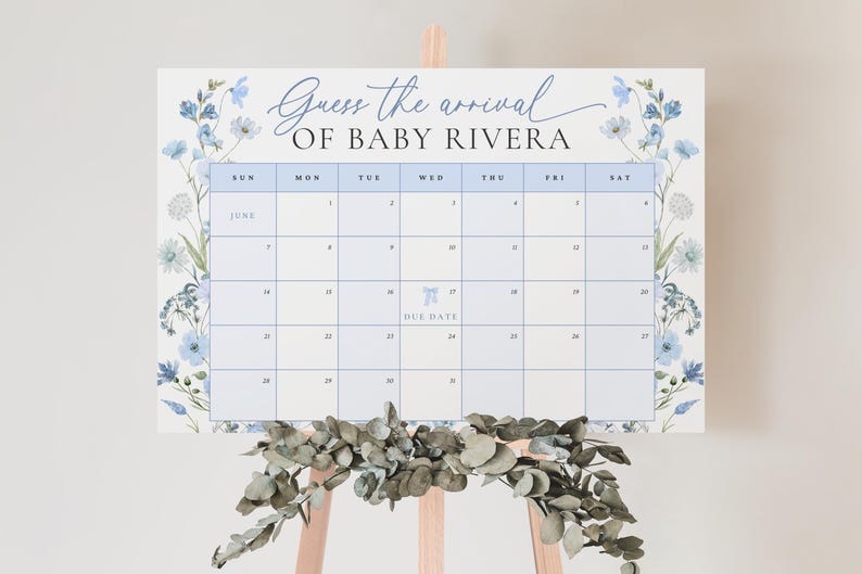 May include: A blue and white floral themed baby shower game with a calendar for guests to guess the arrival date of Baby Rivera. The due date is circled on the calendar.