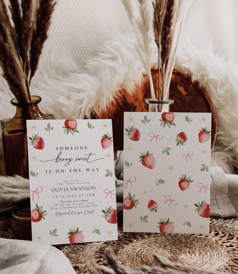 May include: A baby shower invitation with a watercolor illustration of strawberries and pink bows. The text reads "Someone berry sweet is on the way" and includes the name Olivia Swanson, the date and time of the shower, and the location.