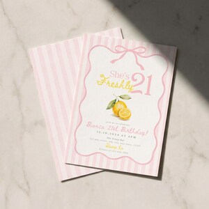 May include: A rectangular birthday invitation card featuring a light pink and white vertical striped background. The front displays a pink bow graphic, yellow text reading She's Freshly 21, a watercolor lemon illustration, and event details for Bianca's 21st Birthday.