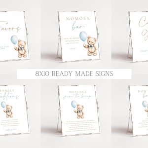 May include: Ten 8x10 inch printable signs for a baby shower. The signs feature a teddy bear holding a blue balloon and have text such as "Favors", "Cards + Gifts", "Family Traditions", "Message from the Bump", and "Don't Say Baby".