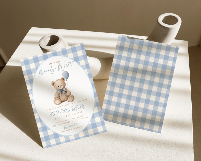 May include: Baby shower invitation with a blue and white gingham pattern. The invitation features the text "We can Bearly Wait" and includes a teddy bear holding a balloon. The invitation also includes the name "Victoria Rivera" and event details.