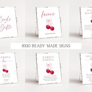 May include: Set of ten 8x10 inch printable signs for a cherry-themed baby shower. The signs feature pink and red cherries with pink bows and white text. The signs include "Cards & Gifts", "Favors", "Message from the Bump", "Mimosa Bar", "Family Traditions", and "Don't Say Baby".