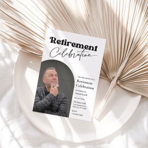 May include: A white card with black text announcing a retirement celebration for Aaron Loch. The card includes the date, time, location, and RSVP information. A photo of Aaron Loch is in the background.