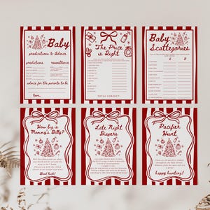 May include: Six baby shower game cards with red and white striped borders. Each card features a different game, including "Baby Predictions & Advice" and "Pacifier Hunt." The cards have festive illustrations and text.