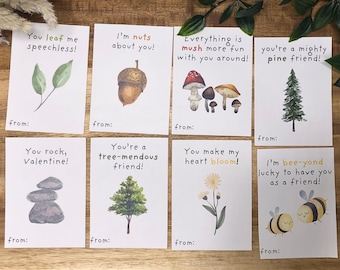 May include: Printable Valentine's Day cards with nature-themed illustrations and puns. The cards feature images of leaves, acorns, mushrooms, pine trees, rocks, a tree, a flower, and bees. The text on the cards includes phrases like "You leaf me speechless!" and "I'm bee-yond lucky to have you as a friend!"