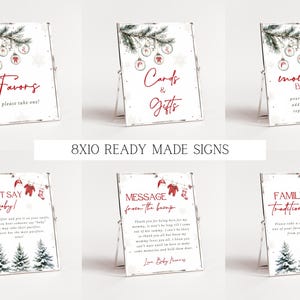 K&ouml;nnte beinhalten: Zehn druckbare Schilder im Format 20,3 x 25,4 cm f&uuml;r eine Babyparty im Winter. Die Schilder zeigen eine Aquarell-Illustration eines Kiefernastes mit Ornamenten und einer rot-wei&szlig;en Baby-M&uuml;tze. Die Schilder enthalten den Text: "Favors, please take one!", "Cards & Gifts", "Mimosa Bar", "Don't Say Baby!", "Message from the Bump", und "Family Traditions".