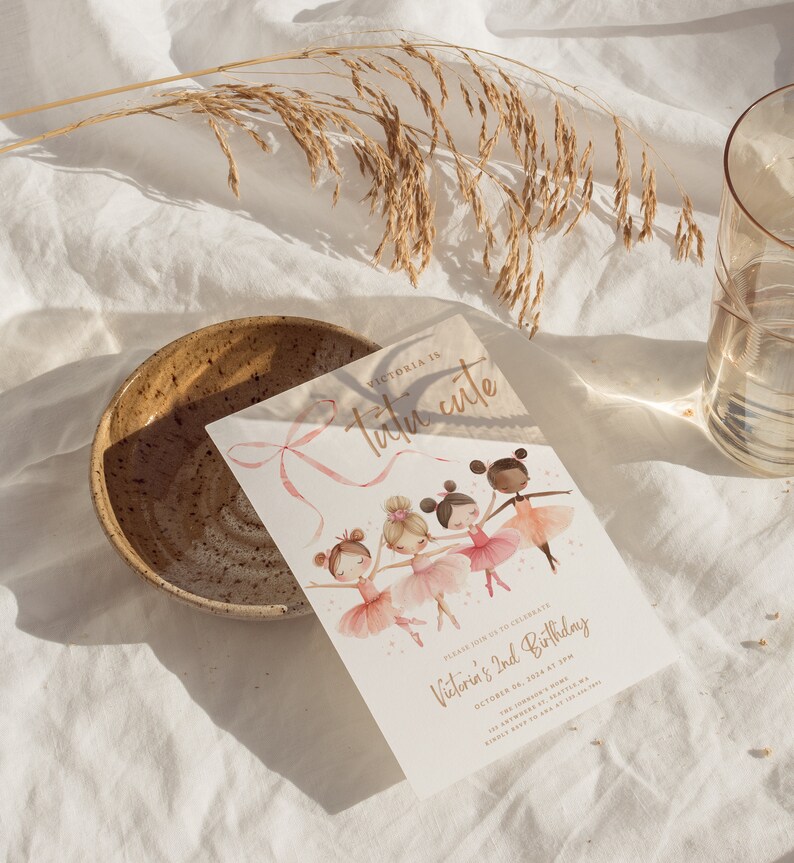 May include: A pink and gold invitation card with a watercolor illustration of four girls wearing tutus and dancing. The text on the card reads "Victoria is tutu cute" and "Please join us to celebrate Victoria's 2nd Birthday, October 14, 2014 at 1pm".