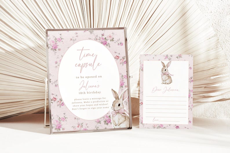 May include: Pink floral time capsule sign with a bunny illustration and the text "Time capsule to be opened on Julianna's 18th birthday. Please leave a message for Julianna. Make a prediction or share your hopes and wishes! Don't forget to sign your name."